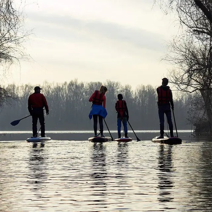 Group of paddleboarders in life jackets on the water near Giethoorn
