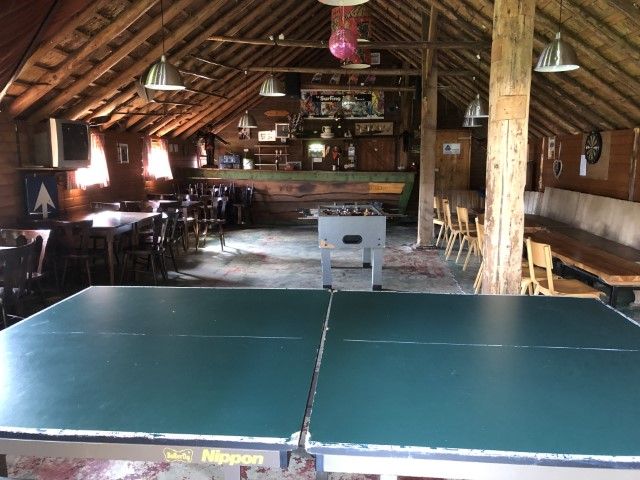 Recreation room De Koestal with table tennis table and wooden beams at Camping D'Hof