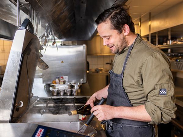 Cook at work in the kitchen of Grand Café Fanfare