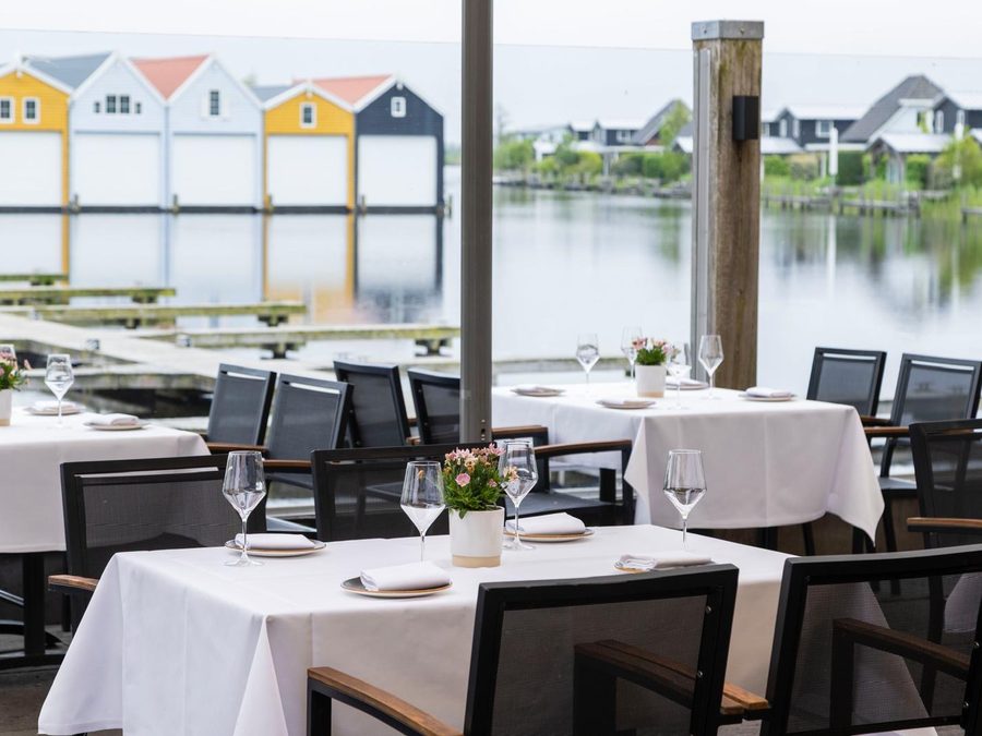 Laid tables on the terrace of Villa Bodelaeke with a view over the harbour