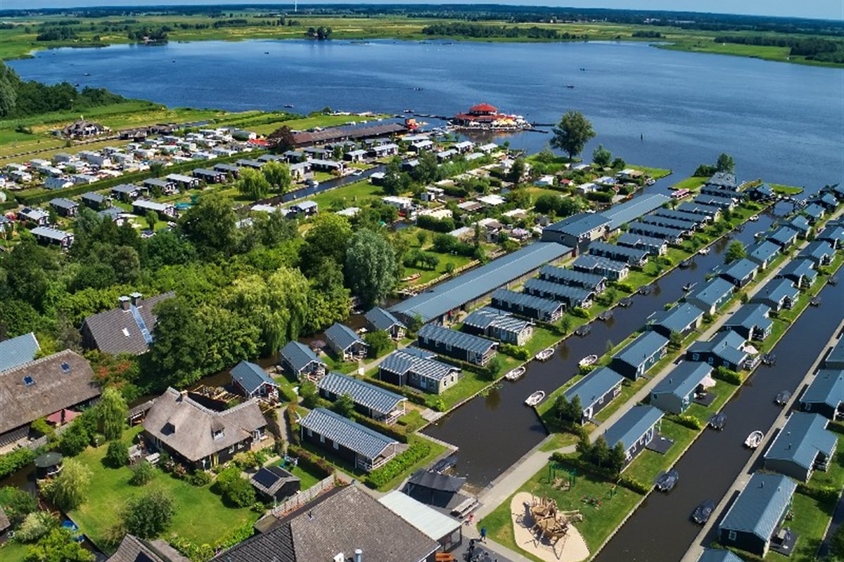 Aerial view of a holiday park with chalets by the water near Giethoorn